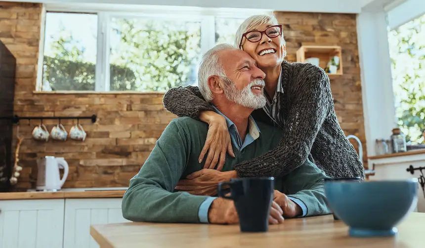 Photo of a smiling older couple embracing