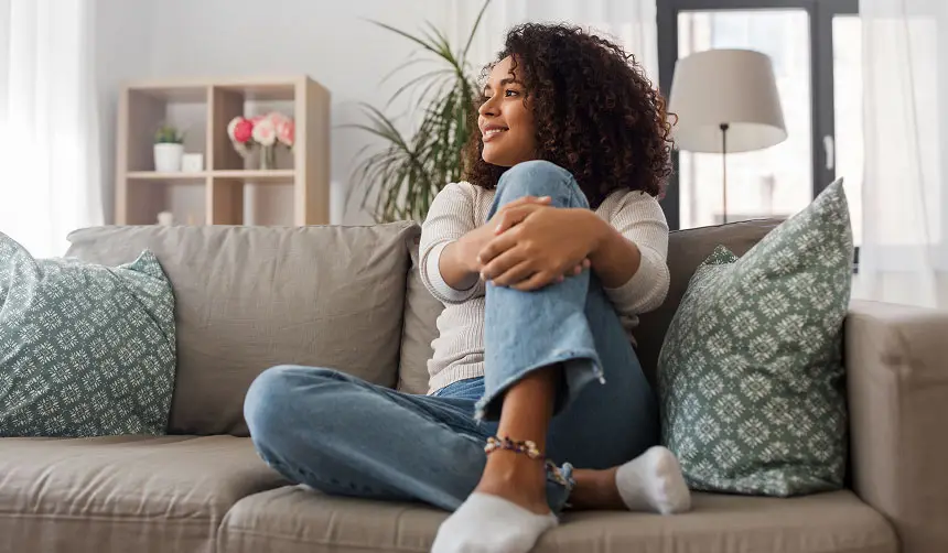 Photo of a woman sitting comfortably on a sofa